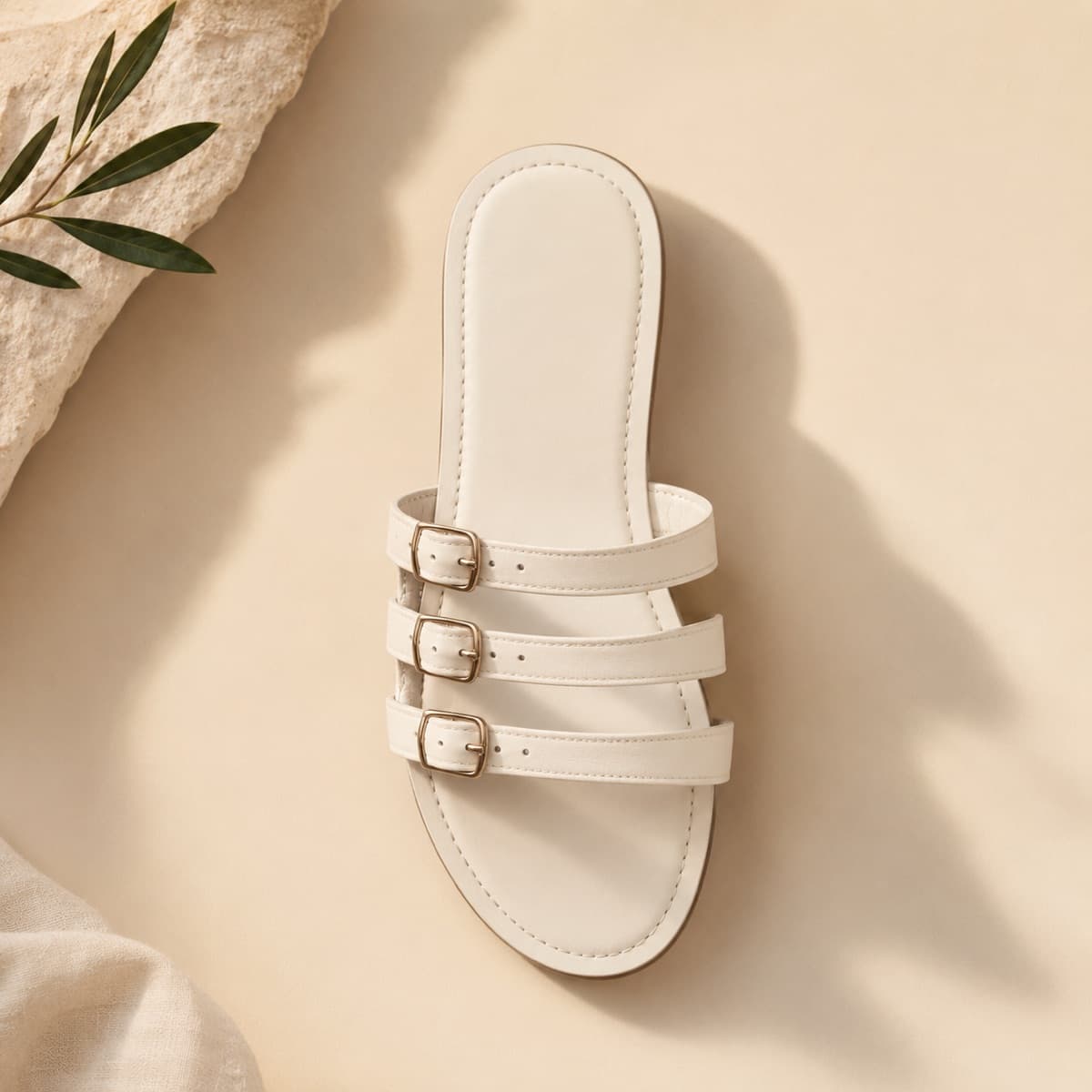 Three-Strap Flat, photographed from above against a sand-beige background