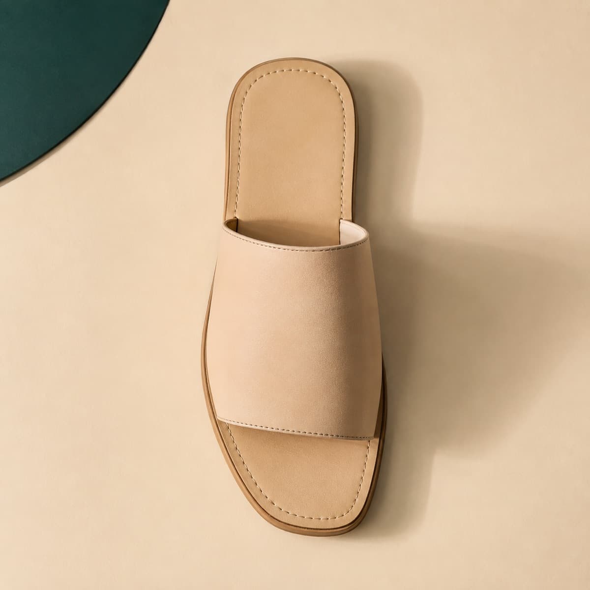 Wide Strap Flat, photographed from above against a sand-beige background
