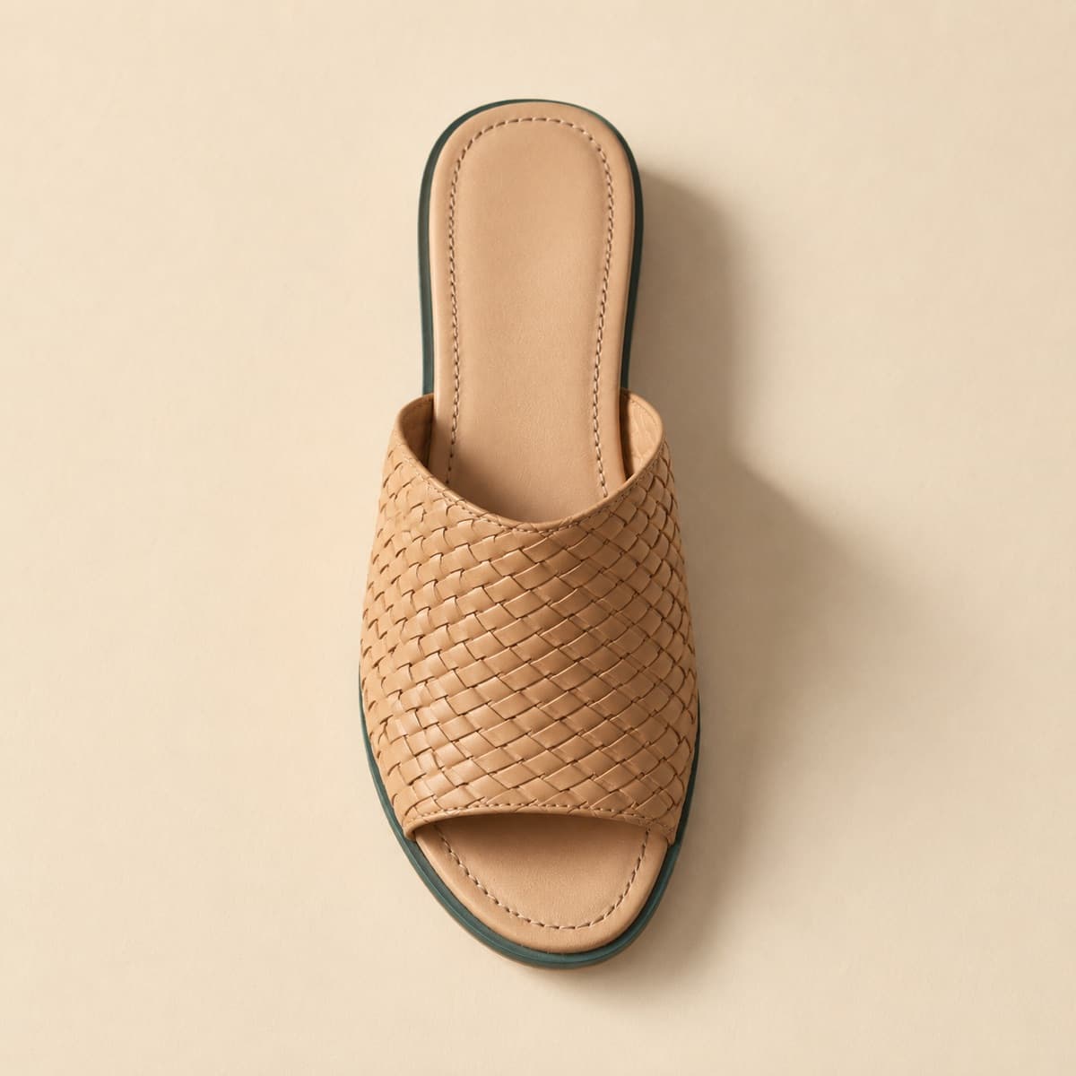 Mule Woven, photographed from above against a sand-beige background