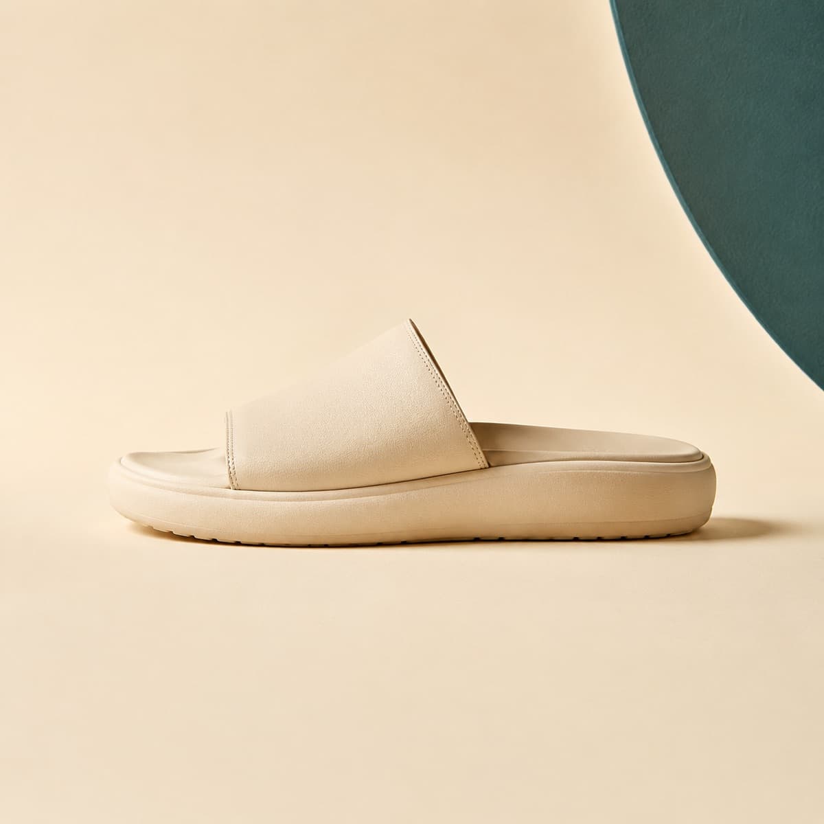Slide Padded, photographed from above against a sand-beige background