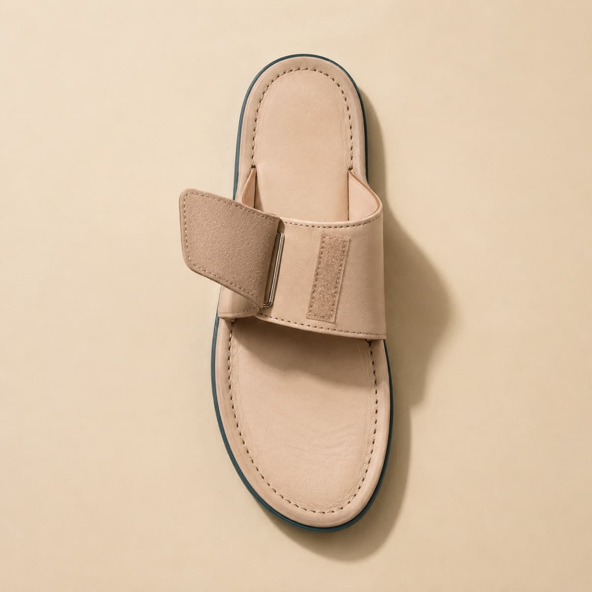 Slide Adjustable, photographed from above against a sand-beige background