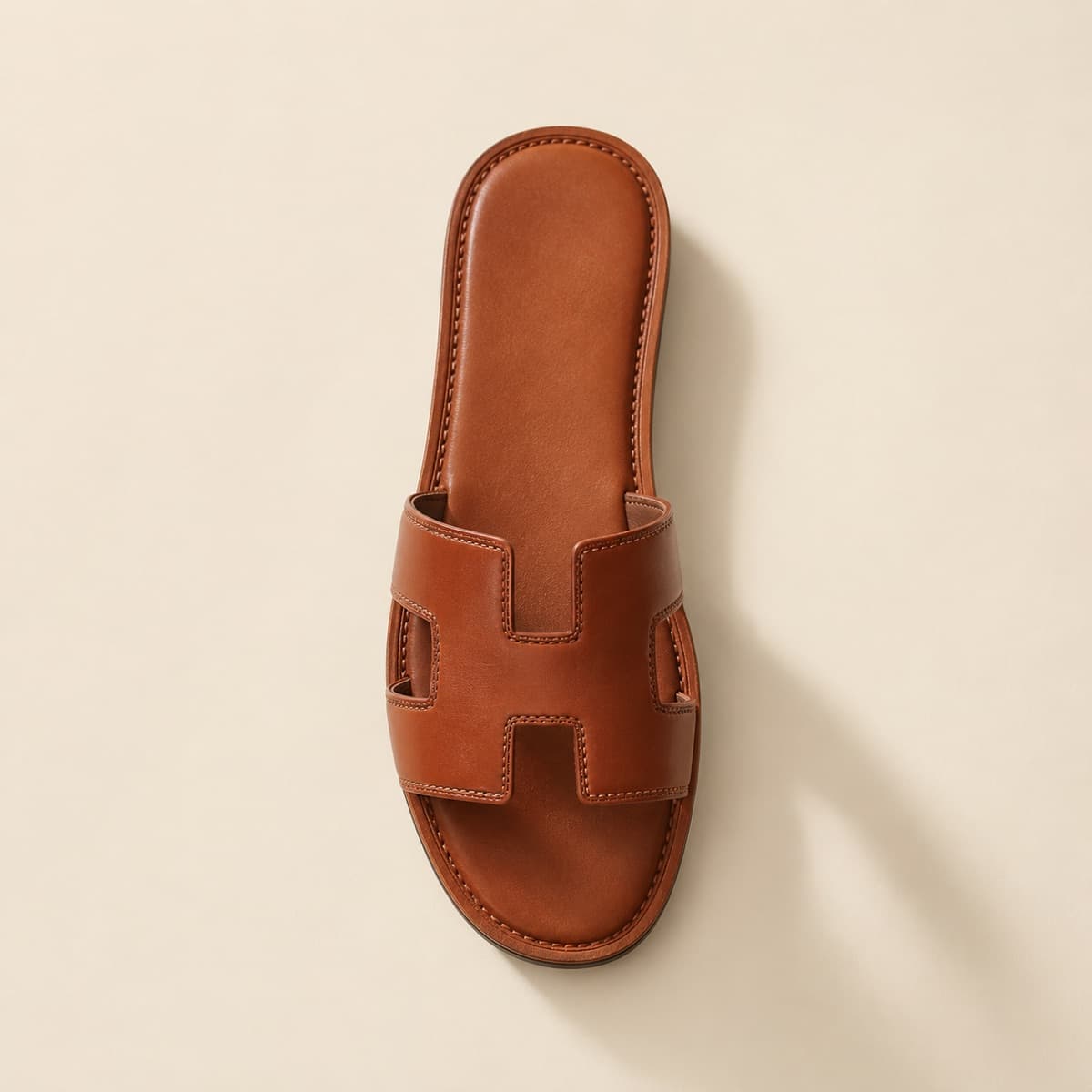 Slide Premium, photographed from above against a sand-beige background